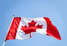 National Flag of Canada Day: Celebrating the Symbol of Unity and Pride A close-up shot of the Canadian flag fluttering against a clear sky