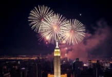 Ultimate Guide to Celebrating New Year’s Eve: Ideas, Wishes, Fireworks, and More A magnificent view of New Year's Eve fireworks illuminating the night sky over a major landmark, epitomizing the excitement and joy of the celebration.