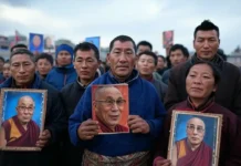 Tibetan Uprising Day: Honoring a Legacy of Courage and Resistance Tibetan exiles gathered in peaceful protest, holding prayer flags and portraits of the Dalai Lama on Tibetan Uprising Day