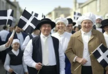 St. Piran’s Day: Celebrating the Patron Saint of Cornwall with Tradition and Pride colorful image of a St. Piran's Day parade in Cornwall festive celebrations.