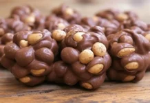 National Peanut Cluster Day: A Sweet Celebration of a Classic Treat peanut clusters covered in chocolate, with some peanuts peeking through.
