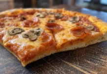 National Deep Dish Pizza Day (April 5th) A pan of freshly baked deep dish pizza with a golden, crispy crust, loaded with sausage and cheese