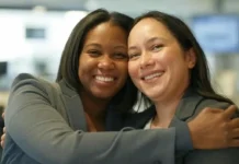 National Hug a Newsman Day (April 4th) Smiling journalist in a newsroom receiving appreciation