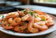National Shrimp Day: Celebrating America’s Favorite Seafood plate of shrimp scampi garnished with fresh parsley and lemon wedges.